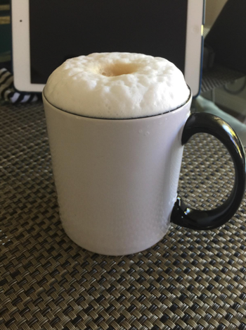 Mug of coffee with frothy froth at the top