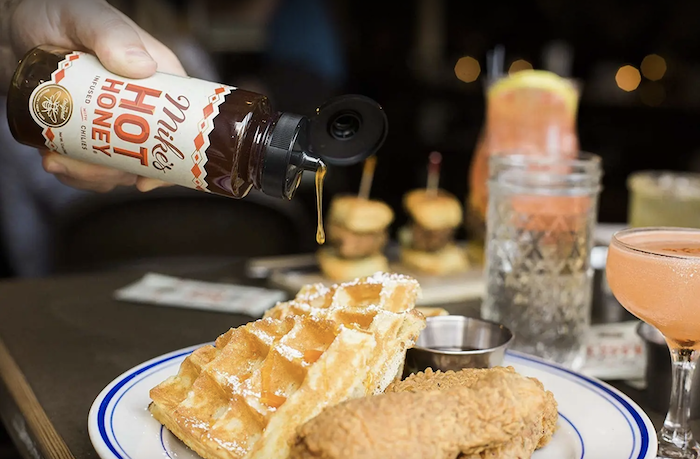 model pouring the hot deliciousness over a plate of chicken and waffles. And suddenly, I want brunch?