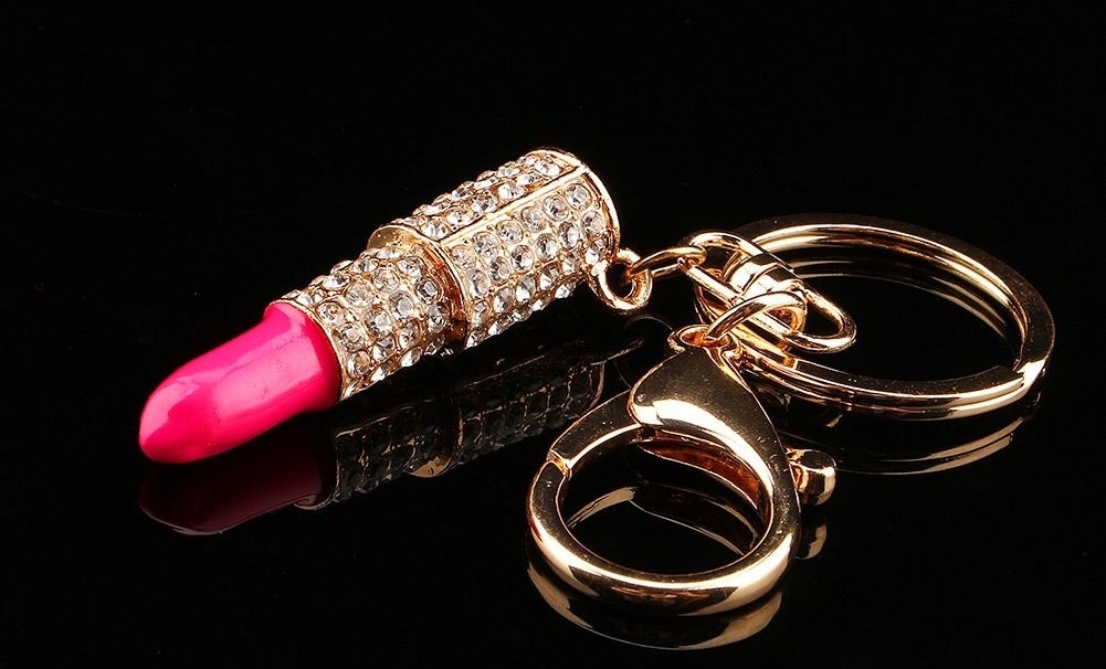 the pink and gold keychain with rhinestones on it 