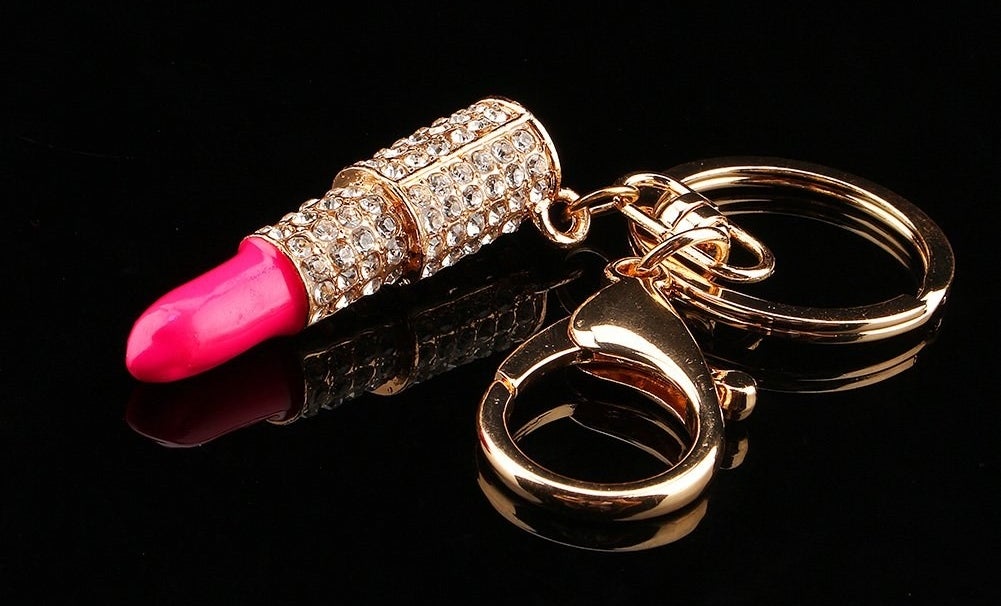 the pink and gold keychain with rhinestones on it 