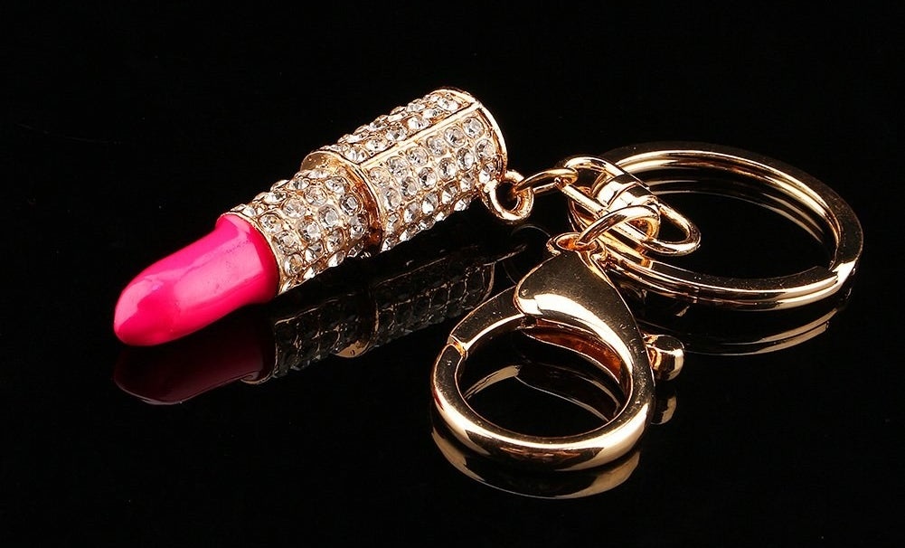 the pink and gold keychain with rhinestones on it
