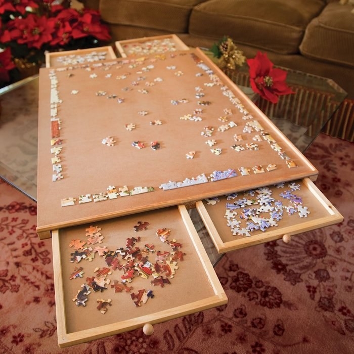 the puzzle plateau with a partially put-together puzzle on the top and two drawers pulled out of the bottom with additional pieces in both