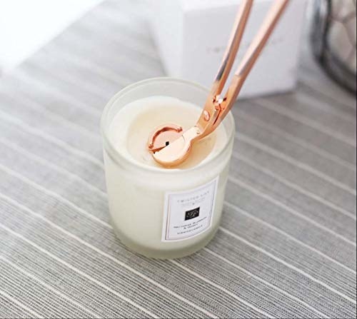 rose gold wick trimmer used on a candle