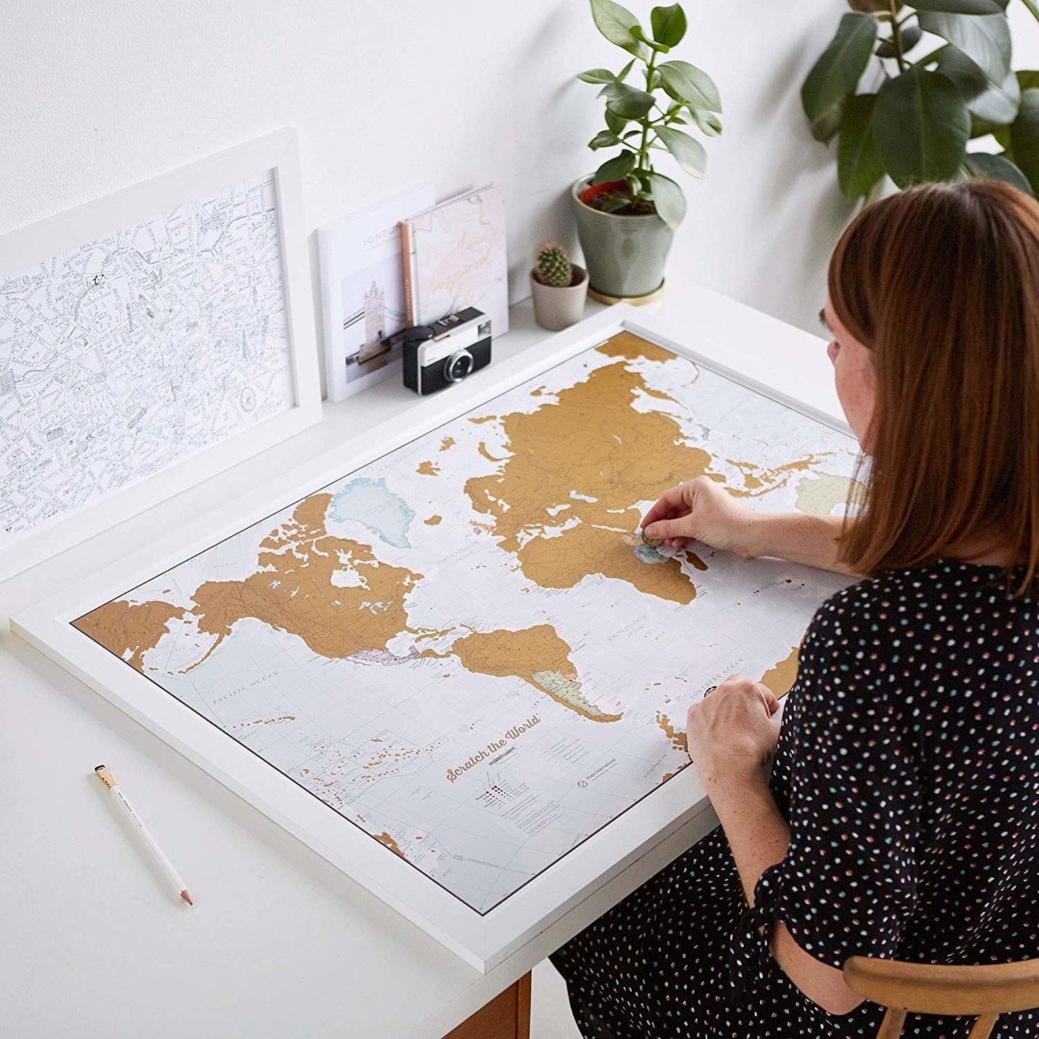 person scratching off map