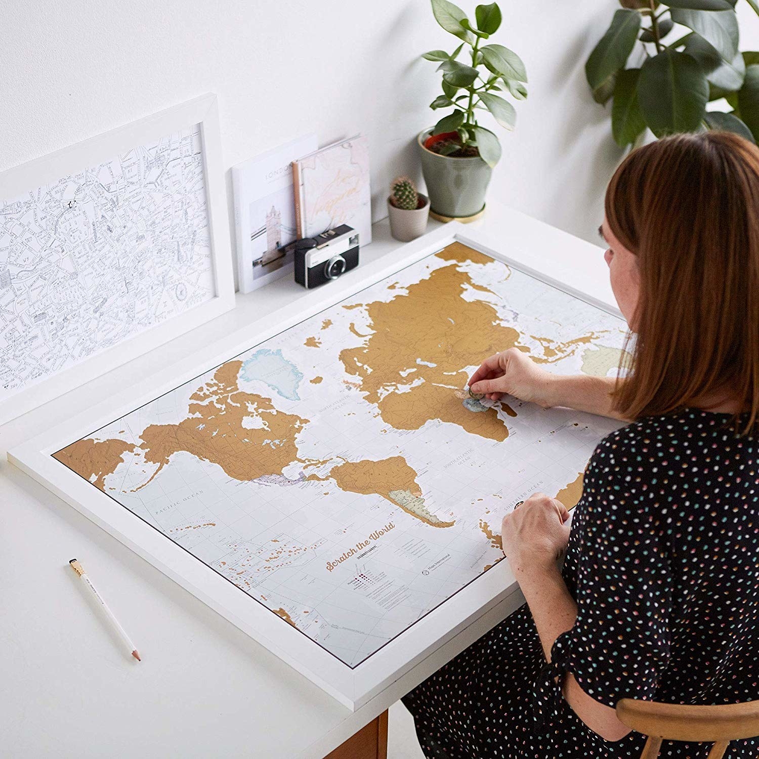 person scratching off map 