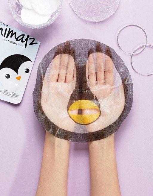 model hands holding the penguin sheet mask