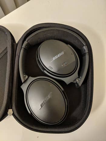 the black headphones folded up in their case