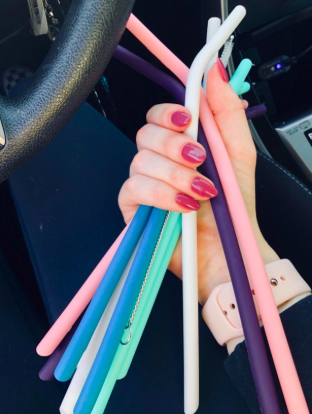 hand holding a bunch of the silicone straws