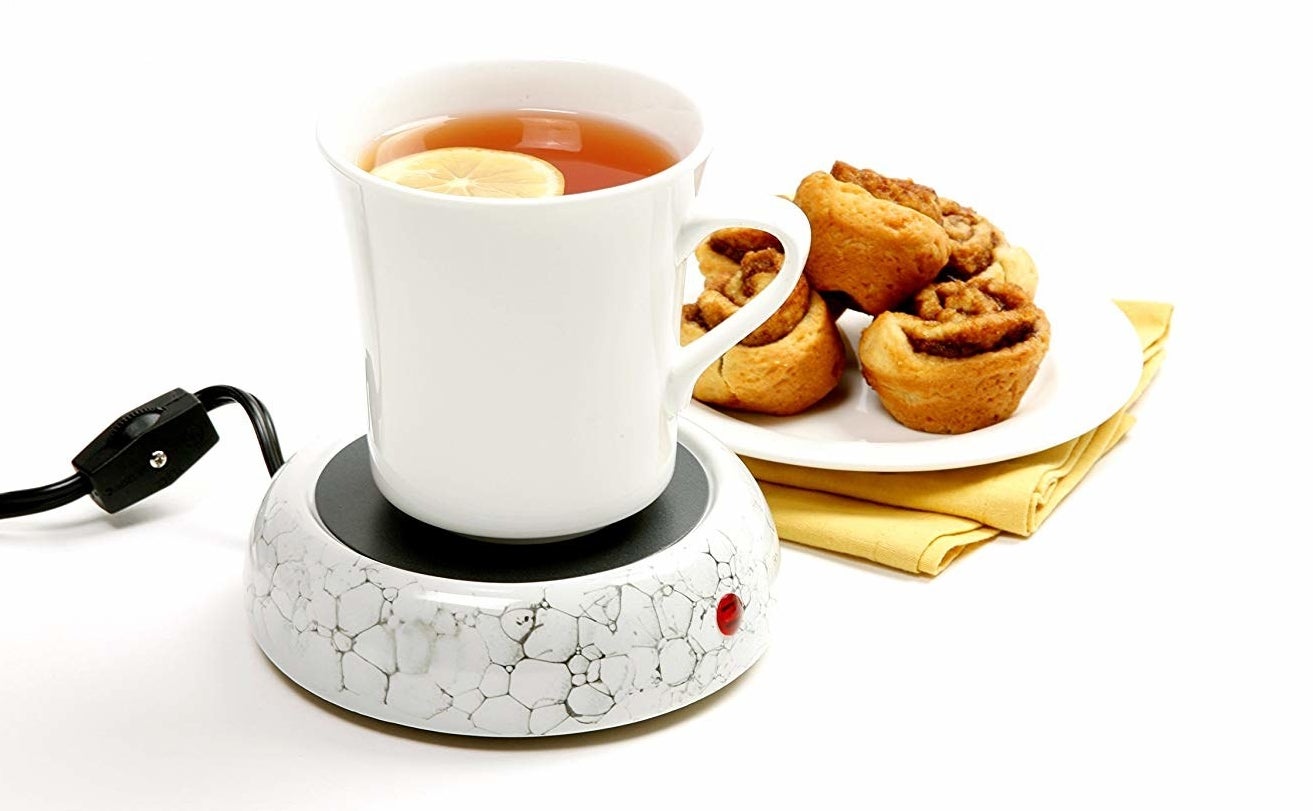 the norpro decorative cup warmer warms a mug of tea