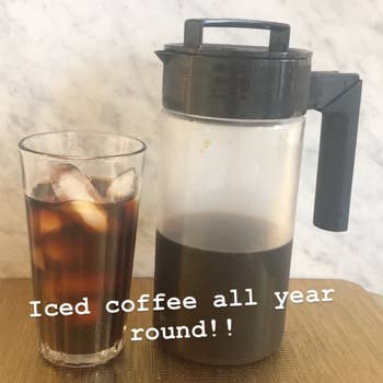 The cold brew coffee maker with coffee in a clear glass with the phrase 