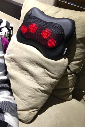 the massager resting on a pillow