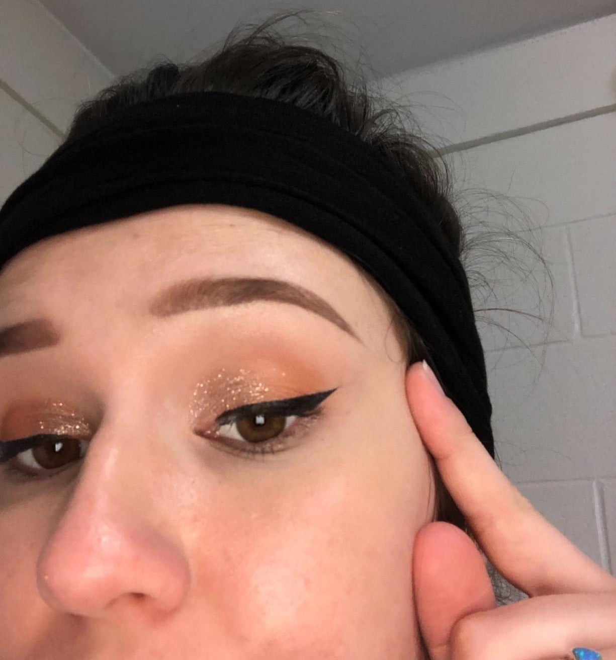 A reviewer showing their eye with a perfect winged eyeliner look