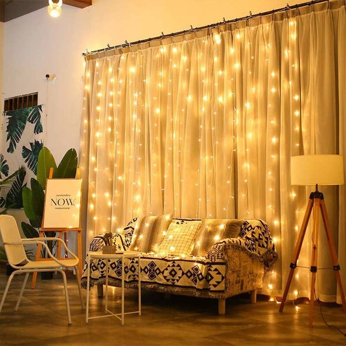 A curtain of fairy lights hung above a sofa
