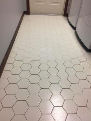 tiled floor with half grout looking black and dirty and the other half looking white