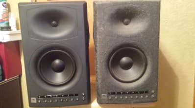 one clean speaker, another speaker covered in sticky dust residue