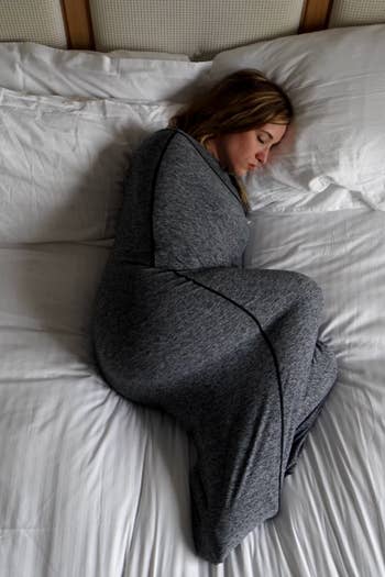 Person sleeping on their side inside tight blanket cocoon 