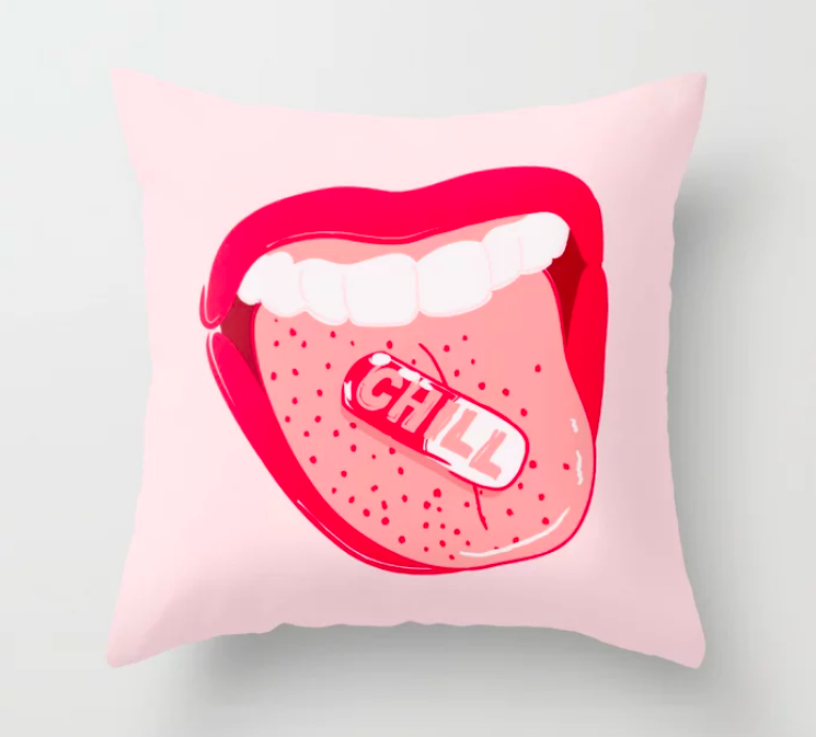 Pink square throw pillow with an illustrated mouth that has a tongue sticking out, showing a pill on it that says &quot;chill&quot; 