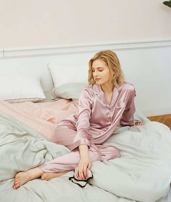model wearing the long sleeved pajamas in bed