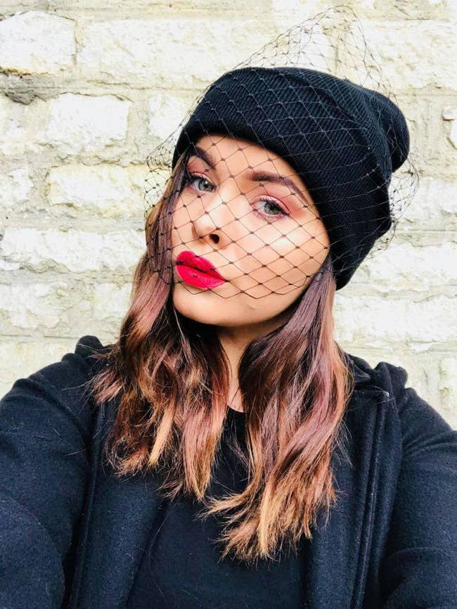 A model in the black beanie with vintagey netted veil