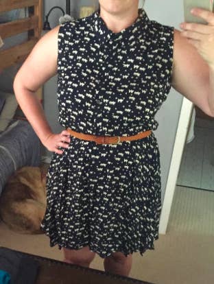 A reviewer wearing the dress in navy and white cat print. it hits above the knee