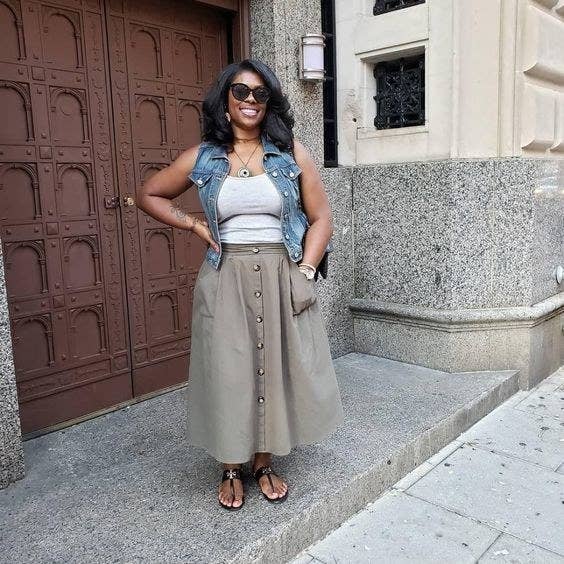 Reviewer wearing the maxi skirt in gray with brown buttons 