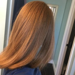 The same woman showing her hair straight and frizzless.
