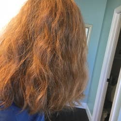 A woman showing her frizzy hair.