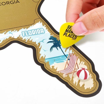 close up of hand scratching off Florida