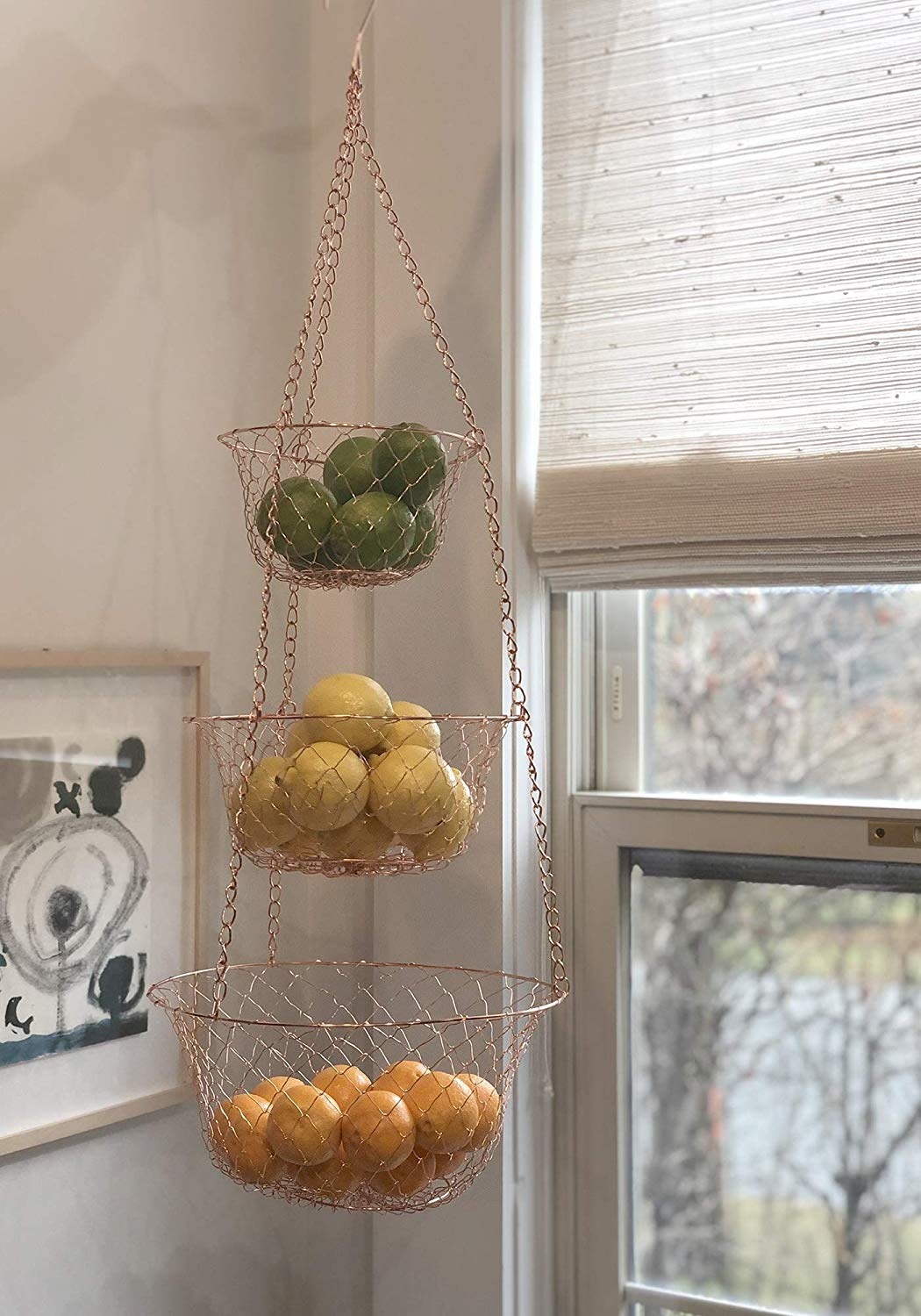 several fruits in the copper tiered baskets