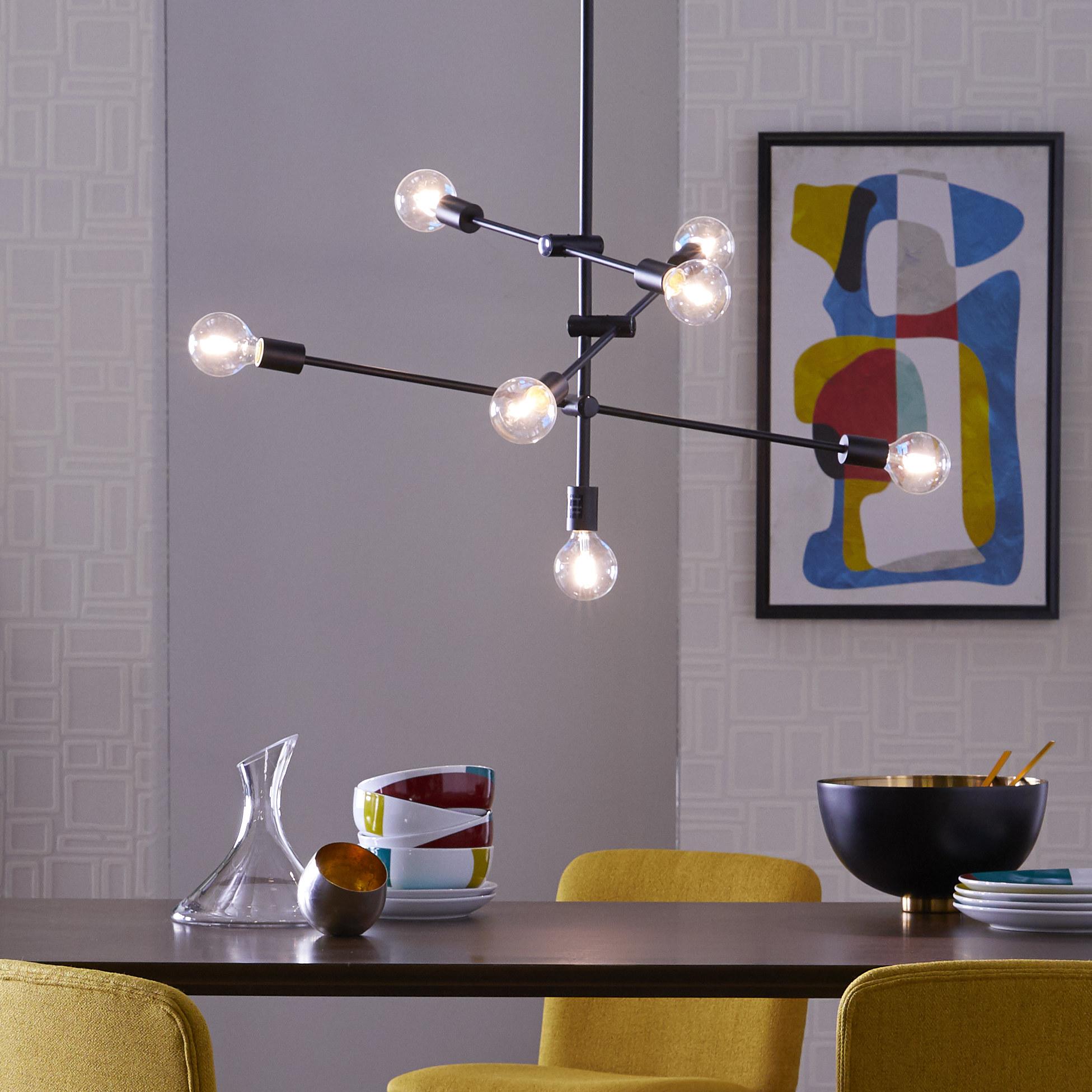 the industrial light fixture over a dining table