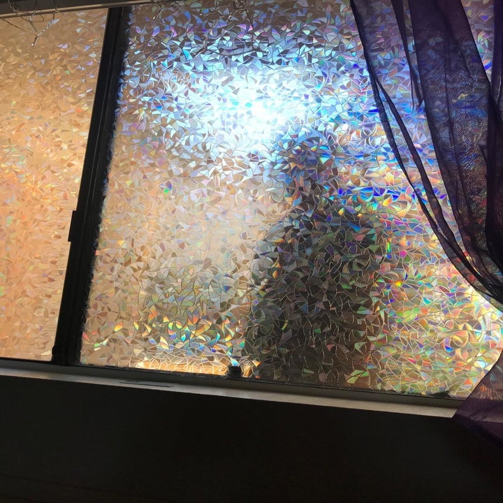 figure obscured behind rainbow textured window film