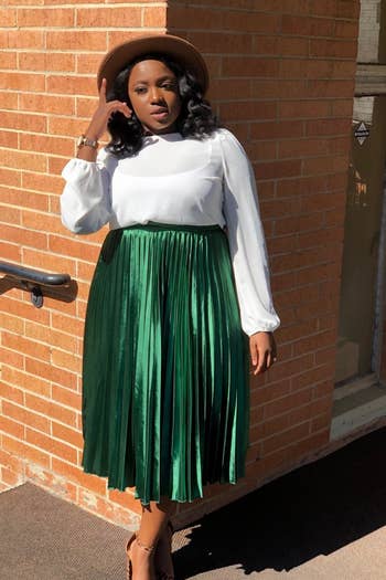 A reviewer in the green midi skirt