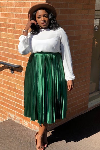 A reviewer in the green midi skirt
