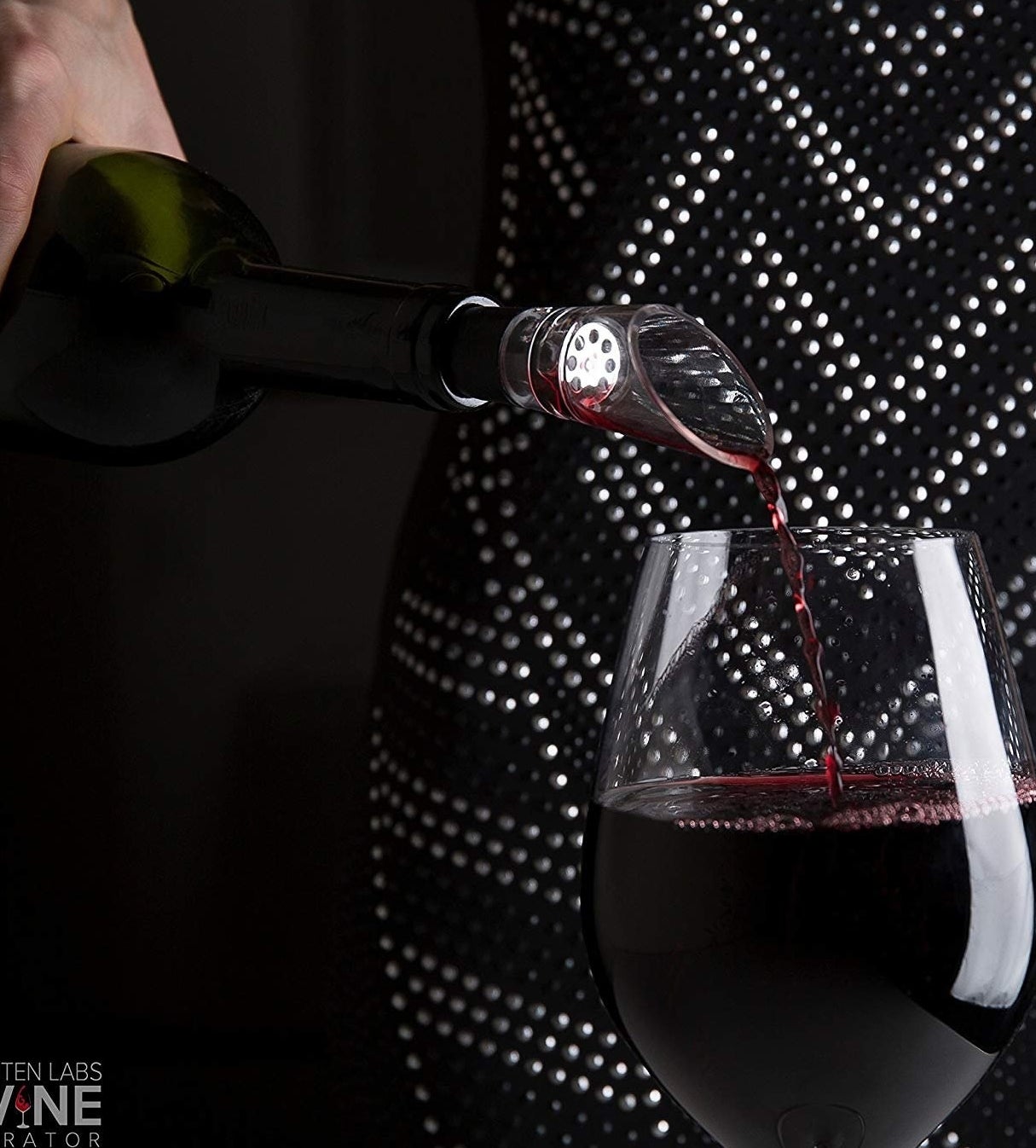 a bottle of wine with clear funnel like aerator on the top 
