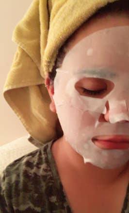 a reviewer wearing the white sheet mask