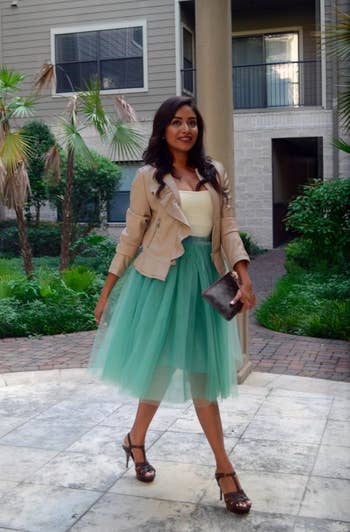 A reviewer in the sea green skirt