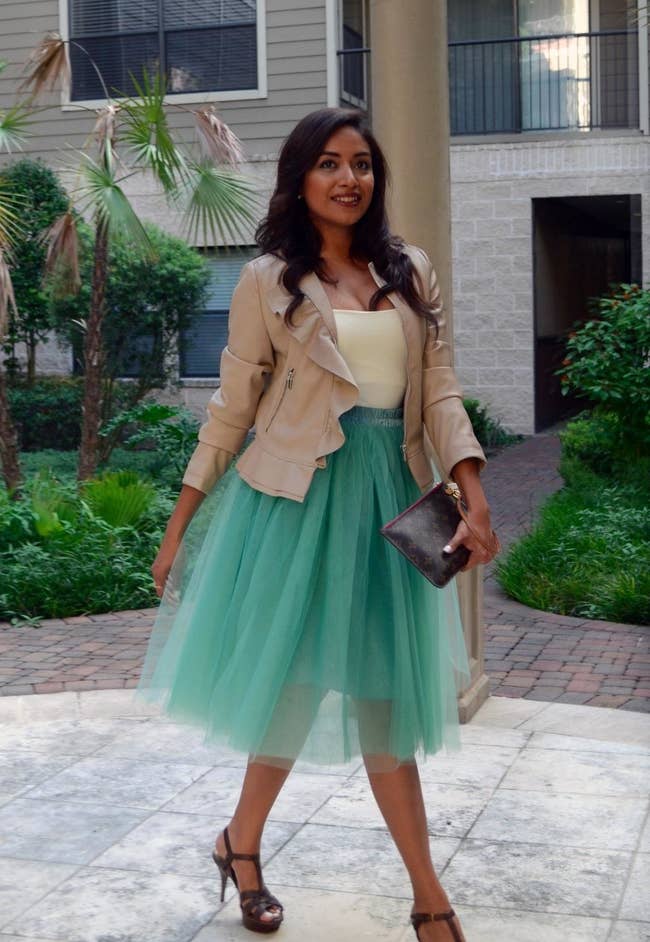 A reviewer in the sea green skirt