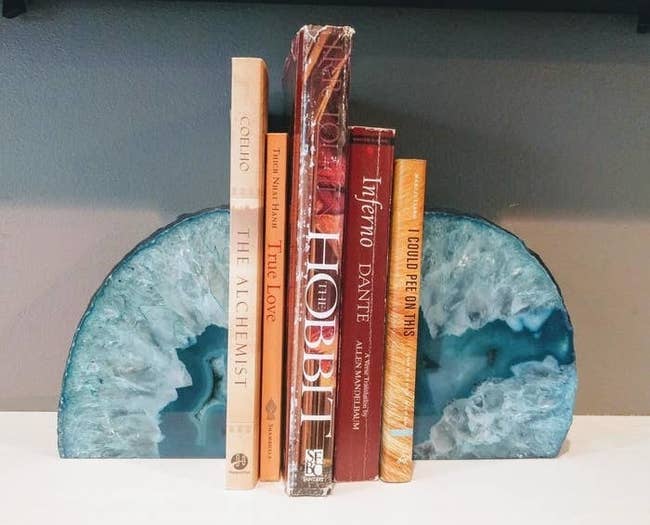 the blue agate bookends holding up five books on a shelf