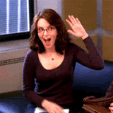 A GIF of Tina Fey giving herself a high five