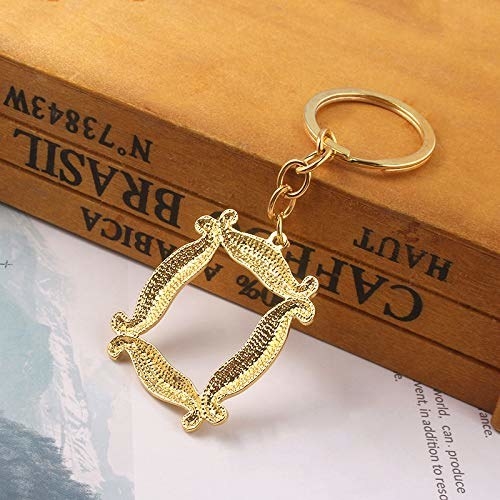 a gold keychain that looks like the friends frame