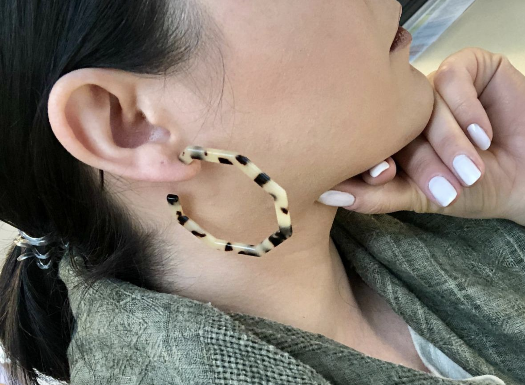 reviewer wearing earrings