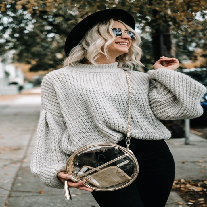 A different reviewer wearing the sweater in light grey