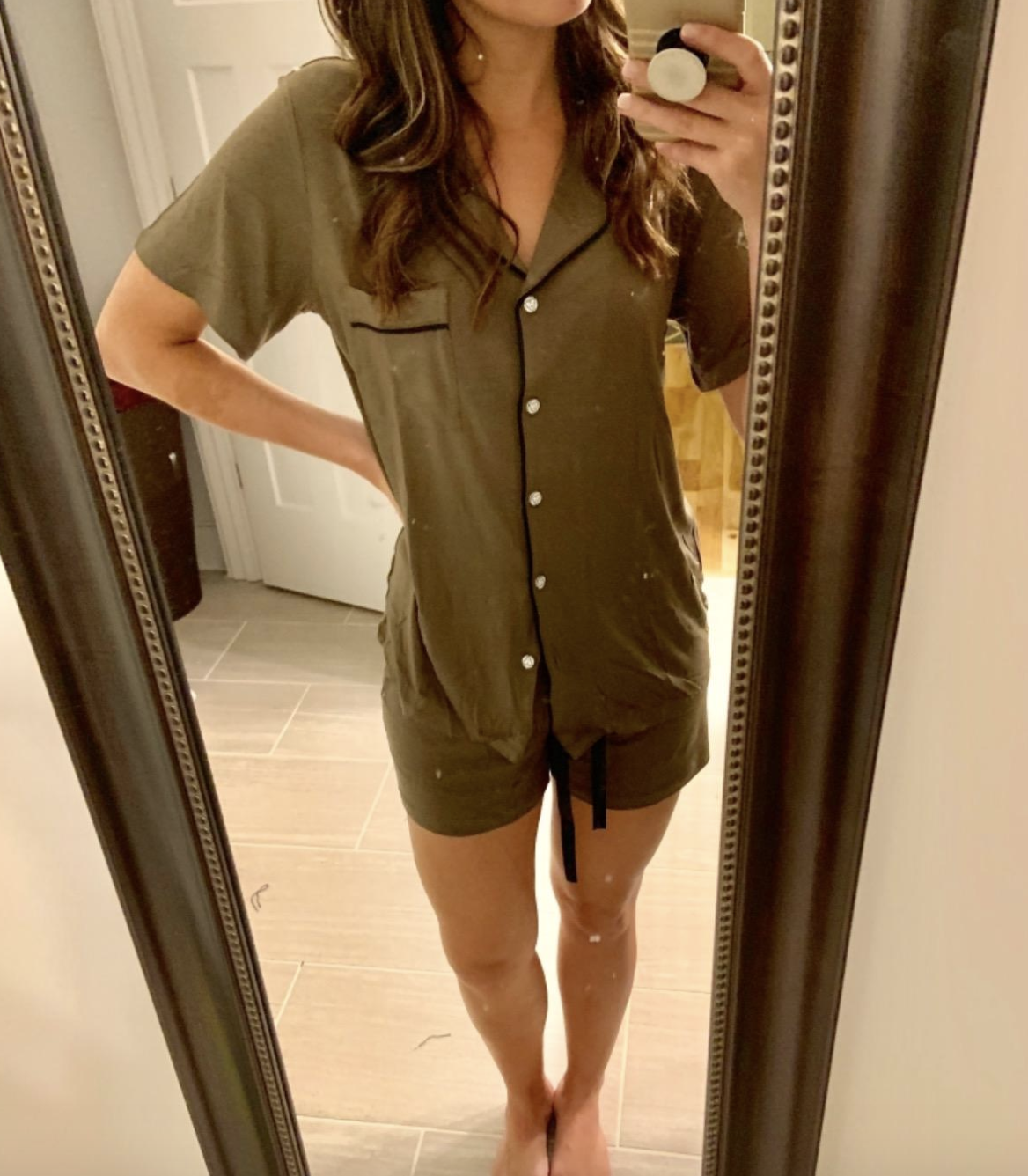 reviewer wearing the shorts and button-down top in olive green