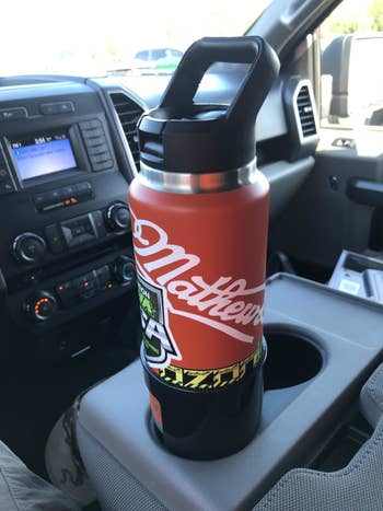 A 36-ounce Yeti bottle sitting in the adapter in a cup holder