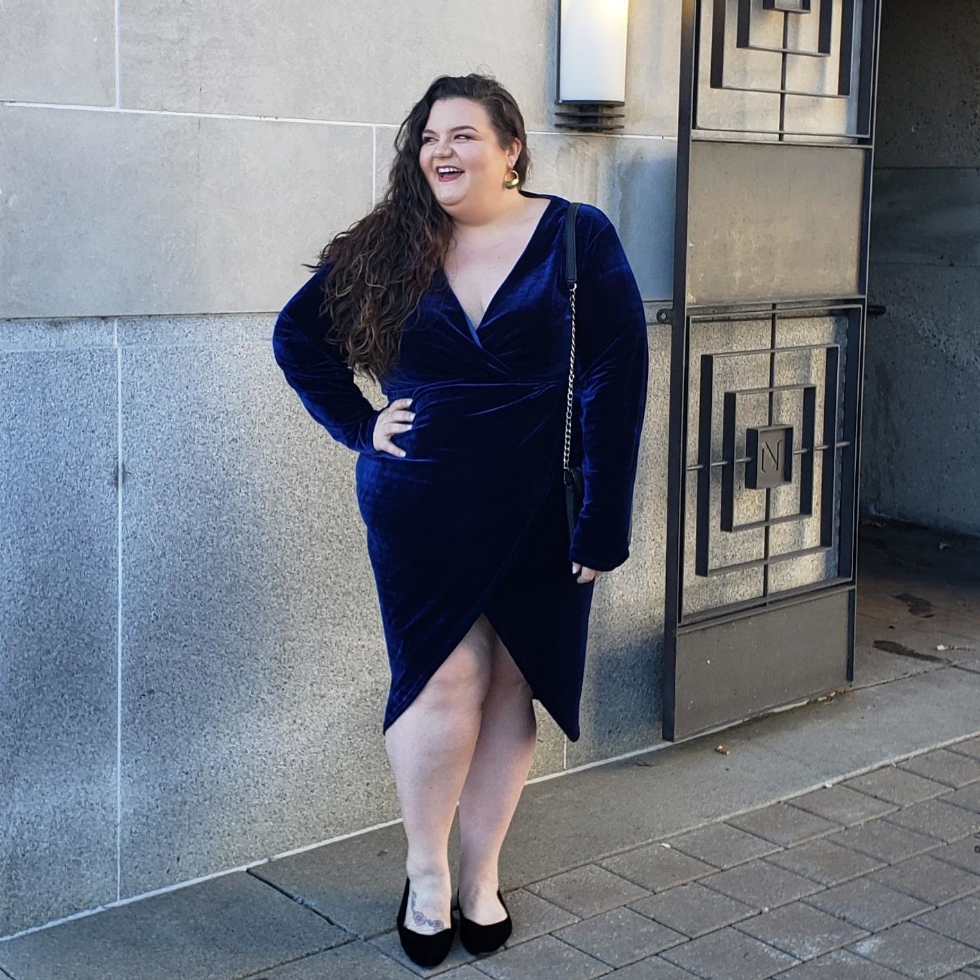 A reviewer in the navy wrap dress