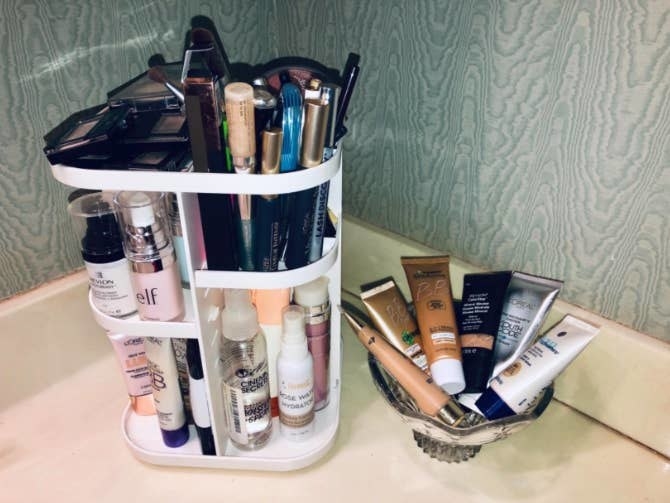 reviewer&#x27;s rotating organizer in white on a counter, filled with makeup and skincare products