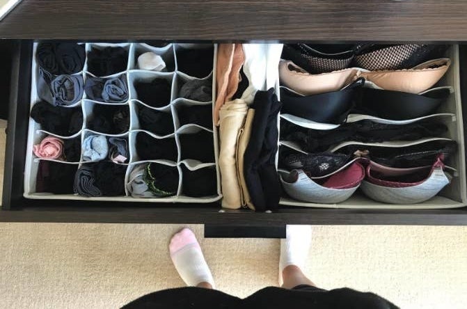 reviewer&#x27;s dresser drawer with the organizers neatly holding their rolled underwear, socks, and bras 