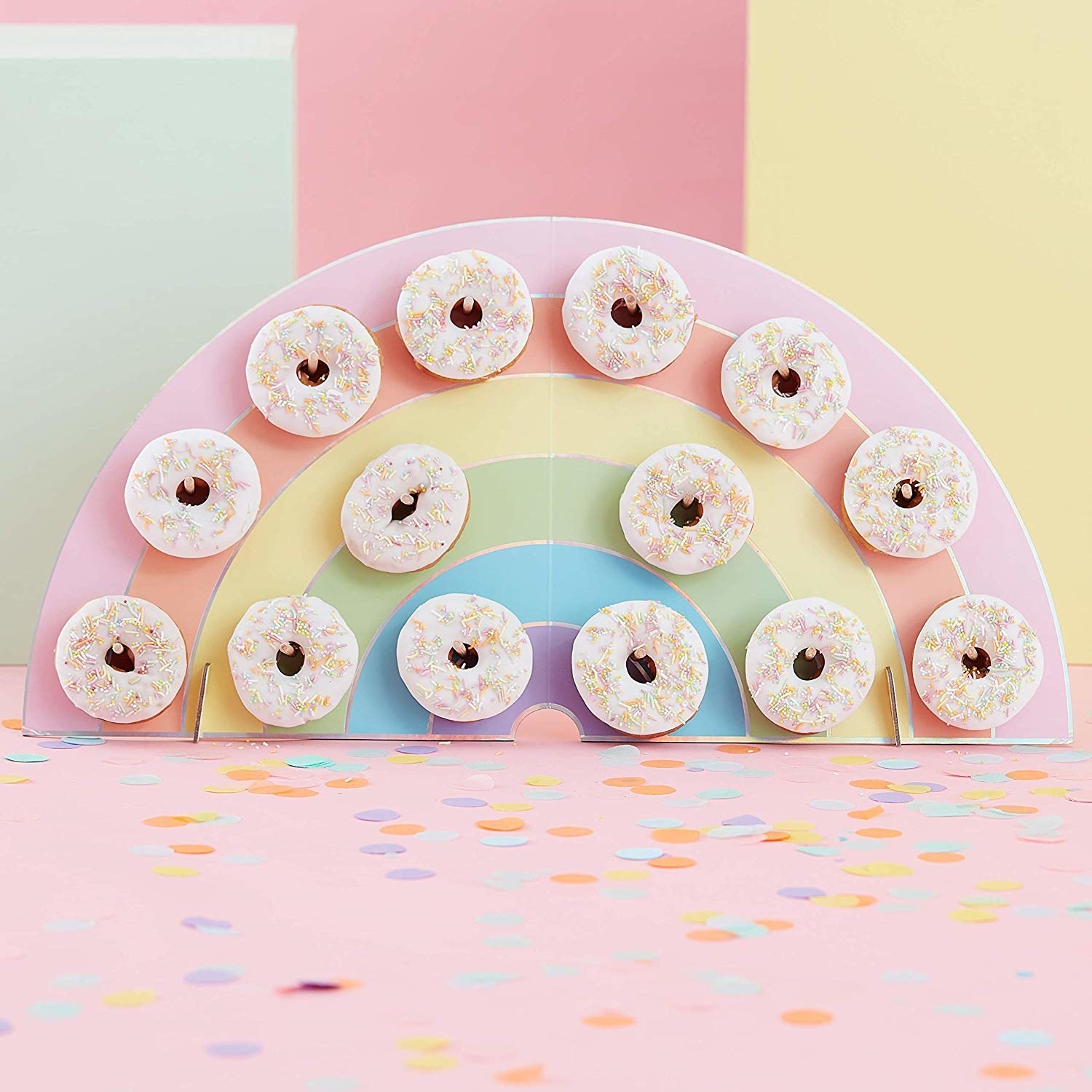 rainbow donut holder with pegs holding 14 doughnuts 
