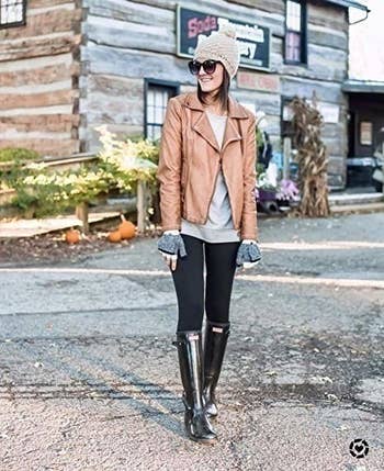 Model wearing the black leggings with rain boots and leather jacket.