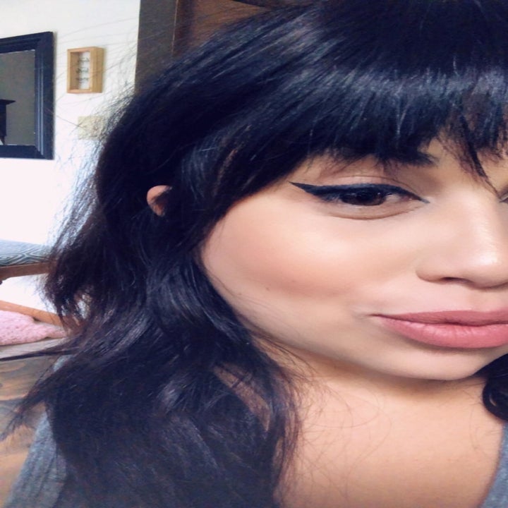 reviewer with perfect flicked liquid eyeliner